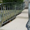 Exterior galvanized railing featuring wrought iron hand forged and tapered square picket with circular ribbon feature - P15C/06