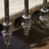 Side-mount bracket example, painted black with silver patina finish, on granite steps